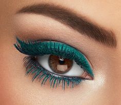 a woman's eye with blue and green makeup on her eyeshadp, showing the