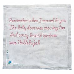 embroidered poem on white cloth with pink writing