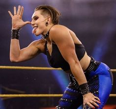 a female wrestler is posing for the camera