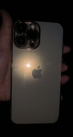 an apple phone is shown in the dark with its light shining on it's back