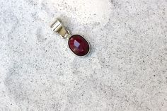 A simple, rare and one of a kind handcrafted pendant showcasing a beautiful red Ruby. All handmade with Sterling Silver .925. The pendant is approximately 19mm L X 10mm W. Red Oval Pendant Jewelry With Polished Finish, Red Oval Faceted Jewelry, Red Faceted Oval Jewelry, Faceted Oval Red Jewelry, Minimalist Red Oval Jewelry, Red Sterling Silver Oval Cabochon Jewelry, Handmade Red Oval Cabochon Jewelry, Purple Labradorite, Star Ruby