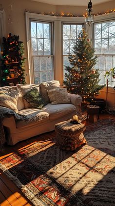 a living room filled with lots of furniture and a christmas tree in the window sill