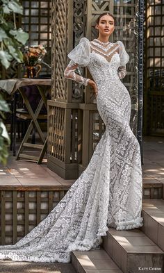 a woman in a white dress standing on steps