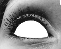 a woman's eye with long lashes and no makeup is seen in this black and white photo