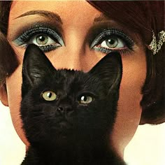 a woman with blue eyes and black cat's head in front of her face