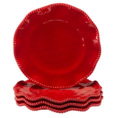 four red plates stacked on top of each other in front of a white background,