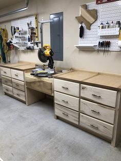 a workbench with many drawers and tools on it