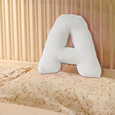 a white pillow sitting on top of a bed