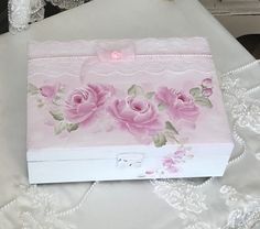 a white box with pink roses painted on it