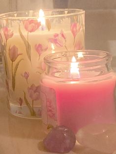 two candles sitting next to each other on a table