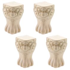 four white ceramic figurines sitting next to each other