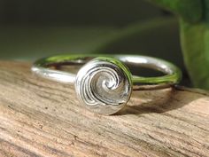 Simple sterling silver ring with fine silver wave design. These  rings are made to order in your size and look great with other stacking rings.  There is also the option of a plain finish to the earrings or an antique finish. Please make your choice in the second drop box box. Please select your required size from the drop down box. Thanks for looking. Listing is for 1 stacker ring Adjustable Silver Rings With Ocean-inspired Style, Minimalist Sterling Silver Wavy Ring, Handmade Sterling Silver Spiral Rings, Adjustable Silver Ocean-inspired Rings, Metal Clay Rings, Wave Ring Silver, Sterling Silver Rings Simple, Clay Ring, Stacker Rings