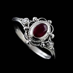 Victorian Oval Ruby Diamond Twisted Swirl Design Open Filigree 14K White Gold Bezel Set Engagement Ring Stunning, romantic Victorian style engagement ring made of 14K white gold. Features a bezel set oval ruby (~1/2ct) and two small diamonds (.06cttw, G-SI1 quality). Stones are enveloped in intricate open filigree and twisted wire design giving the ring the vintage luscious feel. Sizes: 4-8 (smaller and larger sizes are available as custom orders.) PROUDLY MADE FROM SCRATCH IN NEW YORK CITY. Ple Oval Ruby Engagement Ring, Victorian Engagement Rings, Dresses Classy, Ruby Engagement Ring, 925 Silver Jewelry, Jewelry Wedding, 925 Jewelry, Styl Vintage, Bling Bling