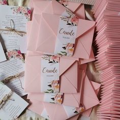 pink envelopes with floral designs and names on them are laid out next to each other