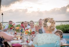 a group of people sitting around a wooden table