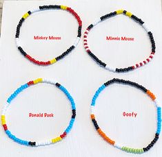 four bracelets with different colored beads and names on them, all in the same circle