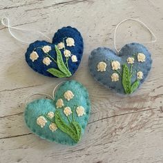 three heart shaped ornaments with flowers on them