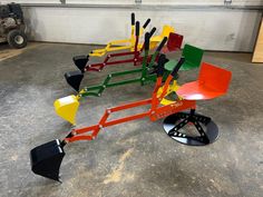 several different types of shovels are arranged in the shape of an upside down lawnmower