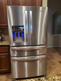 a large stainless steel refrigerator in a kitchen