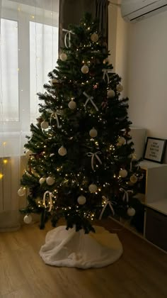 a decorated christmas tree in the corner of a room