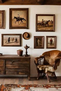 a room with pictures on the wall and an old chair in front of it next to a dresser