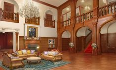 a large living room with wooden floors and chandelier