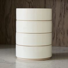 four white bowls stacked on top of each other