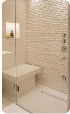 a white bathroom with a glass shower door