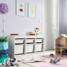 a child's playroom with toys and books on the floor