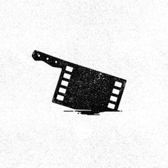 a black and white photo of a movie clapper on the ground with grungy paint