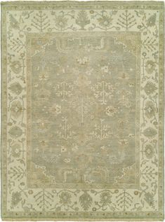 an antique rug with green and beige colors