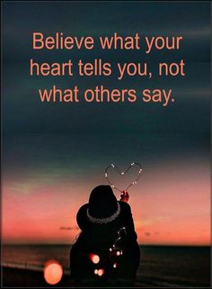 a person holding a heart in their hand with the words believe what your heart tells you, not what others say