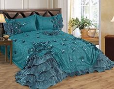 the comforter is made up in teal blue and has ruffled edges on it