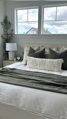 a bed with pillows and blankets in a bedroom