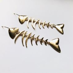 Super cute fishbone dangle drop earrings. We have a matching necklace Not intended for children ages 13 and under. Also, for many items we can accommodate large orders, so please send us a message. Fishbone Earrings, Fish Bone Bracelet, Gold Dangle Earrings With Fish Hook, Fish Bone Earrings, Fish Skeleton Earrings, Gold Fish-shaped Pierced Earrings, Fish Bone Necklace, Fish Skeleton, Bone Earrings