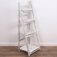 a white wooden ladder leaning against a wall