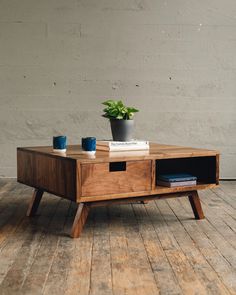 a wooden table with a plant on top