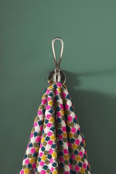 a multicolored towel hanging on a hook