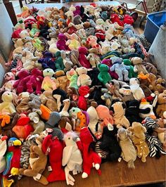 many stuffed animals are laid out on a table