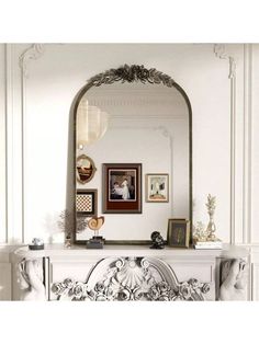 an ornate fireplace mantel with a mirror above it