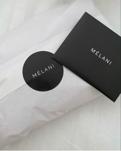 a black and white photo with the name melani on it next to a pillow