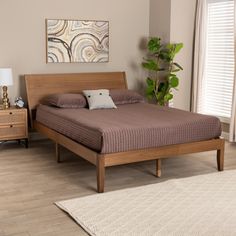 a bed sitting on top of a wooden floor next to a dresser and window in a bedroom