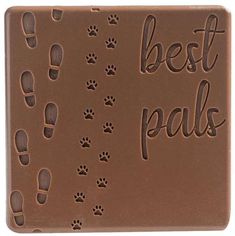 a chocolate bar with the words best pals written on it and paw prints in brown