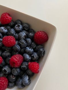 blueberries and raspberries in a white bowl