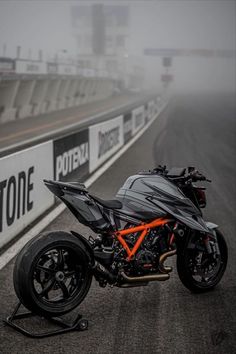 a motorcycle parked on the side of a race track