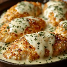 chicken parmesan is served in a skillet with cheese and herbs on top