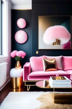 a living room with pink couches, gold accents and paintings on the black wall