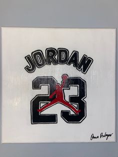 the jordan 23 logo is displayed on a white wall in front of a gray background