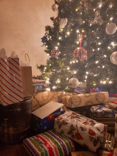 a christmas tree with presents under it