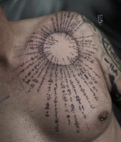 a close up of a man's chest with lots of writing all over it